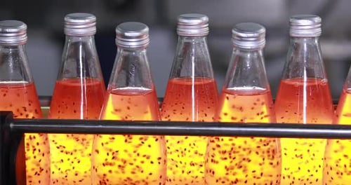 Lots of glass bottles drinks production plant in factory. Food and beverage industry factory concept