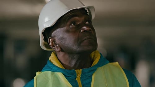 Construction Worker Wearing Hard Hat Looking Upwards