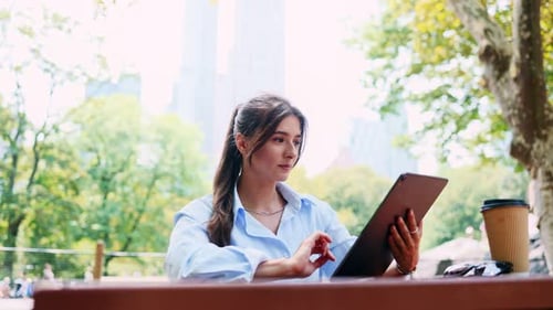 Portrait Cute Lovely Successful Caucasian Woman Sitting in Beautiful Park Holding Tablet Working