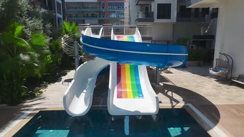 Aerial View Residential Complex With Azure Pool and Kids' Water Park By the Sea