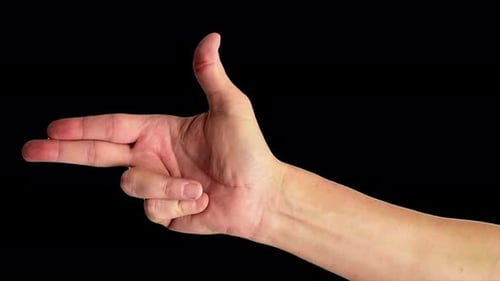 Close up shot of a male hand making the classic fingers gun sign, against a plain black background