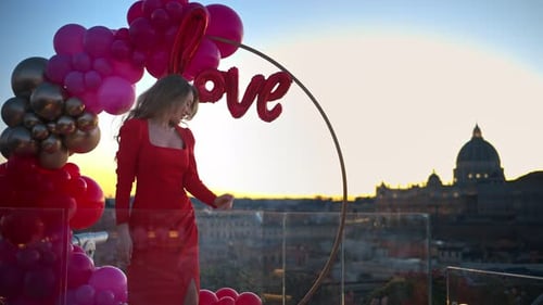 Woman Posing With Balloons in City at Sunset