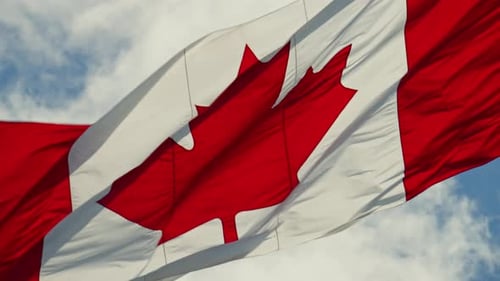 Canadian Flag Waving in a Blue Sky