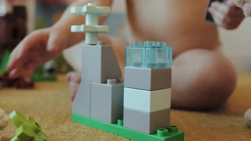 Child Playing with Building Blocks on Carpet