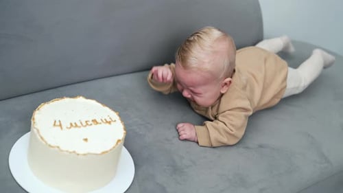 Baby Celebrates Birthday With Cake on Sofa