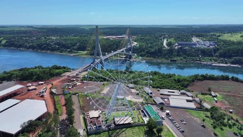 Drone view of Ferris wheel with individual cabins and 88 meters high, on the right Integration Bridg