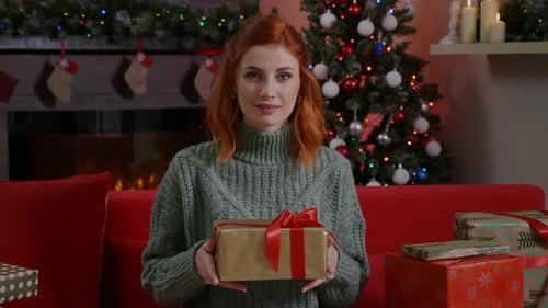 Happy Woman Presents Christmas Gift with Love