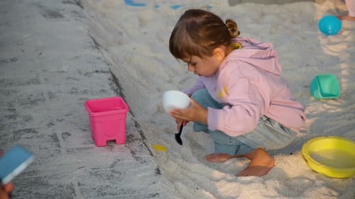 Little Girl Playing at Seasalt Sand Pit Playground at Saltern Gaetgol Eco Park