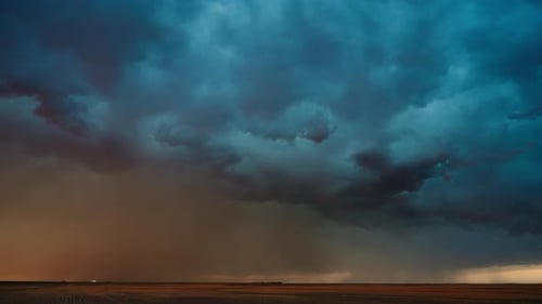 Dramatic Storm Clouds Over Rural Landscape at Sunset
