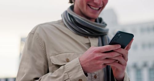 Young Man Using Cell Phone Outside