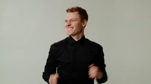 A Happy Smiling Winsome Guy is Dancing Joyfully with Energetic Fervor A Young Businessman or Boss