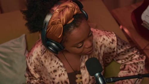 High Angle of Female Performer Singing in Microphone in Studio