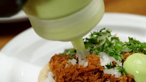 Preparing Delicious Taco with Meat and Green Sauce