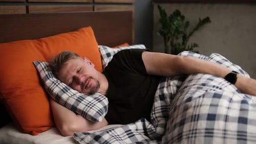 Man Sleeping On Bed In Bedroom