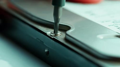 Close Up of Screwdriver Removing Hard Drive Screw