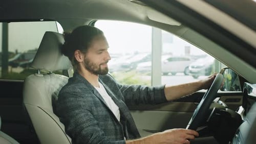 Man Looking at a Car in a Car Showroom Portrait Happy Smiling Young Man Buyer