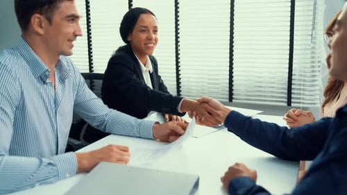 Business People Handshake at Conference Table