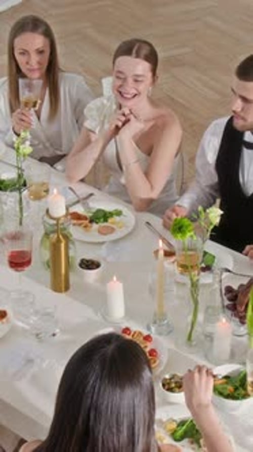 Friends Celebrate With a Toast at Festive Table