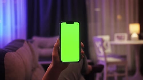 Woman Using Phone with Chroma Key Green Screen Watching Video or Having Online Conference Close Up
