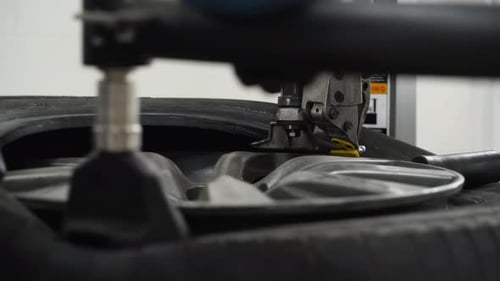 Auto Mechanic Removes Tire From Rim with Machine Workshop Tech Operates Tire Changer Vehicle