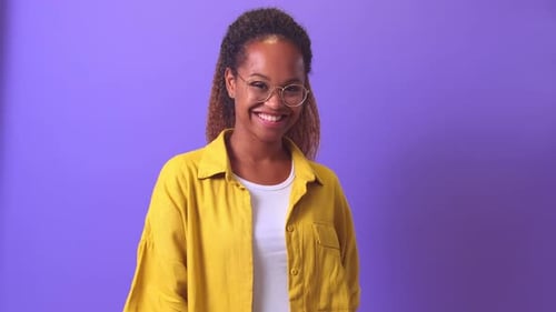Smiling Young Woman with Glasses in Studio