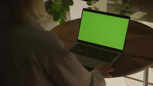 Woman Using Laptop With Green Screen