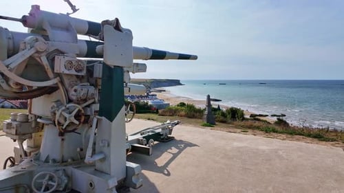Smooth panning movement and close-up view about the World War II coastal military gun, Arromanches,
