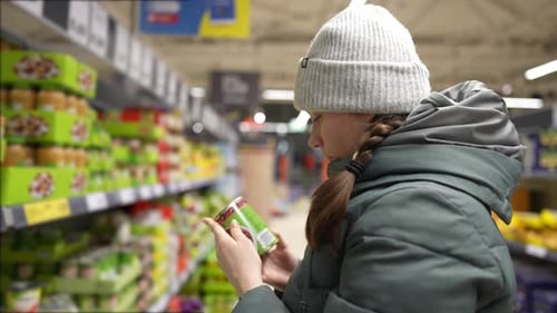girl chooses groceries in a network grocery store, discounted goods