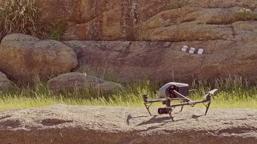 A Quadcopter Drone Blades Slowly Spinning Prepares To Take-Off Then Flies Away - Medium Shot