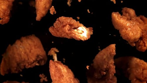 Crispy Fried Chicken Pieces Falling in Slow Motion