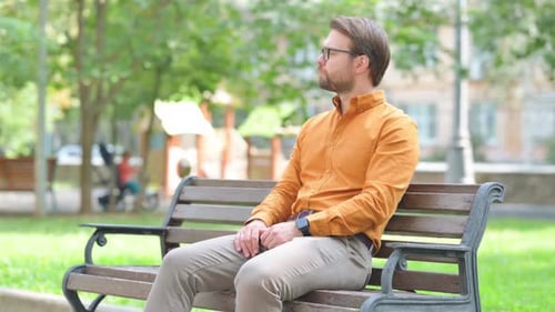 Man sits outside in the park