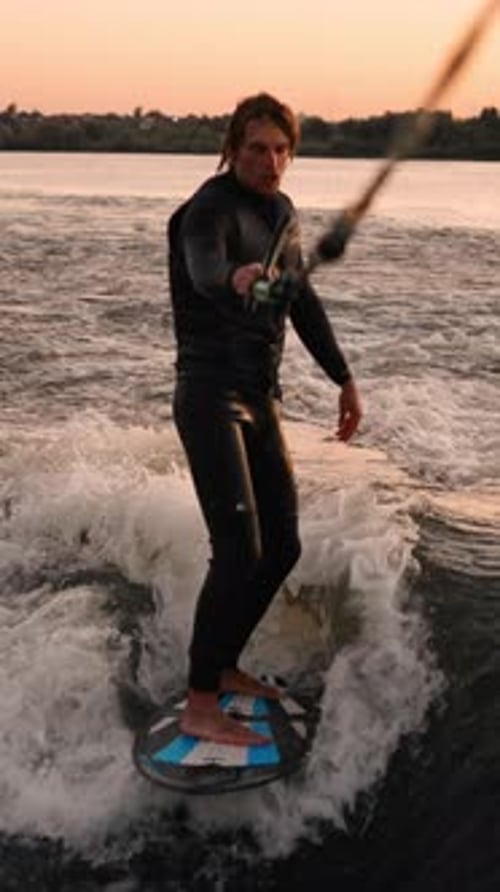 An Adventurous Surfer Riding the Waves at Sunset Showcasing Skill and Thrill in a Glorious Display