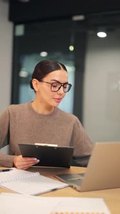 Professional Woman Focused on Business Tasks in Office