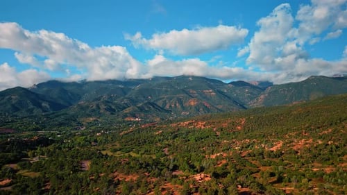Aerial View of Rolling Green Hills and Mountains
