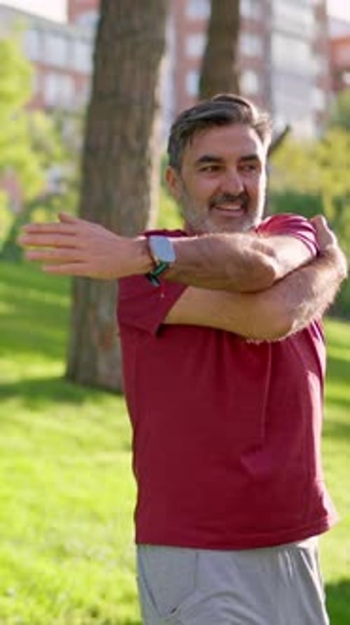 Handsome Senior Man Stretching Arms in the Park