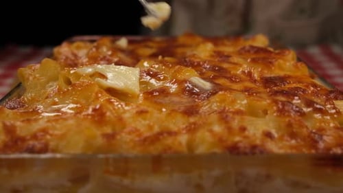 Cutting Macaroni and Cheese in Baking Dish