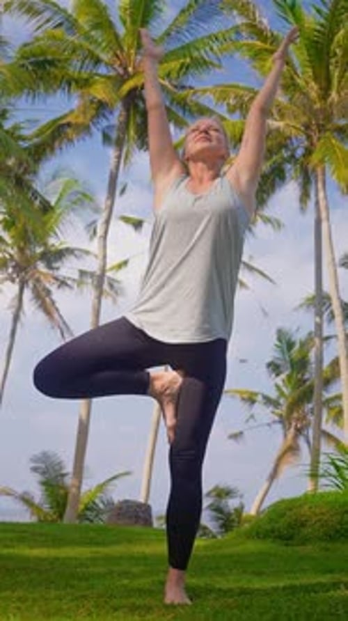 Woman Doing Yoga in Tropical Setting