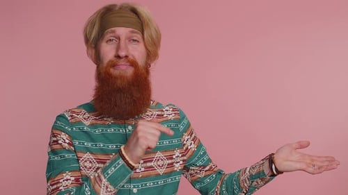 Hippie Man Showing Thumbs Up and Pointing Empty Place Advertising Area for Commercial Text Promotion