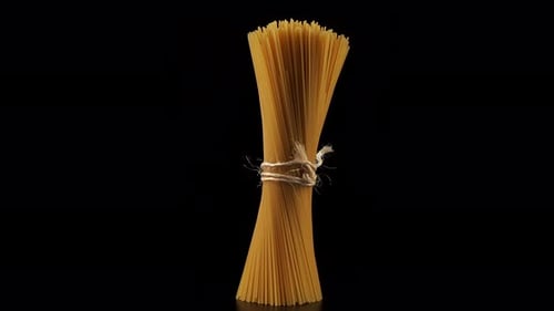 Spaghetti rotates on a black background.
