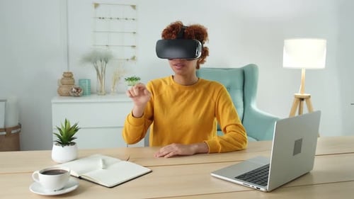 Woman Wearing VR Headset at Desk