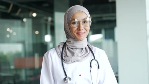 Smiling Woman Doctor in White Coat and Stethoscope