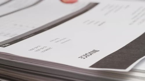 Close Up of Pile of Invoices on Desk