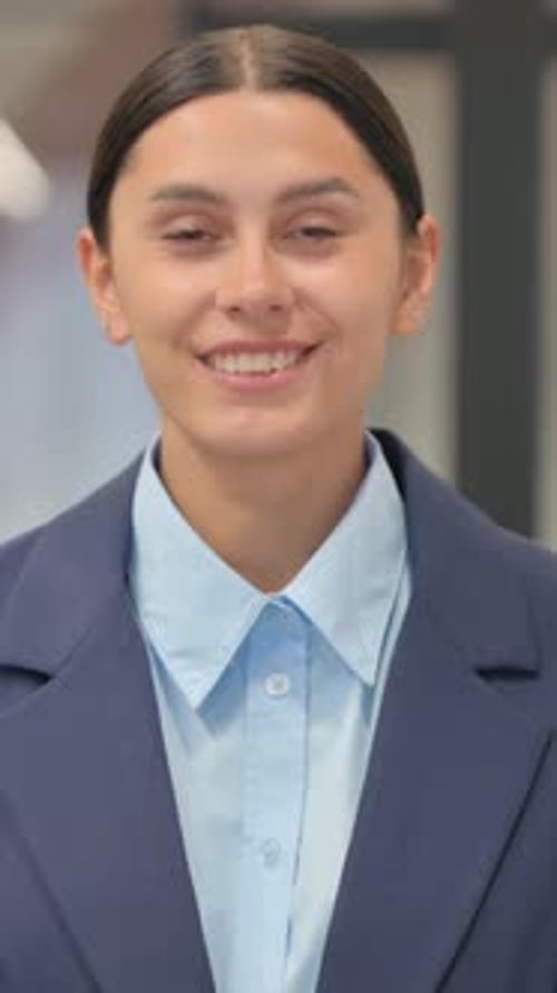 Woman smiling confidently in a business jacket