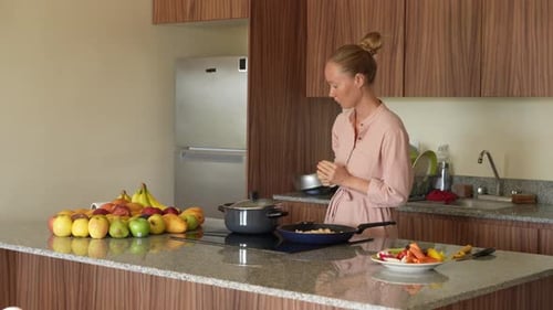 Woman Cooking Fresh Food in Kitchen