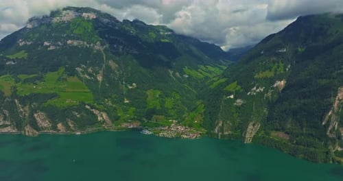 Drone Flies Over Green Picturesque Valley with Mountains in the Background High Mountains Famous