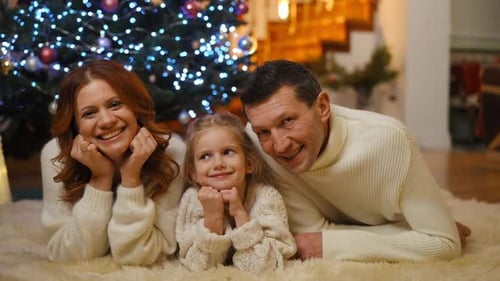 Happy Family Portrait in Front of Christmas Tree