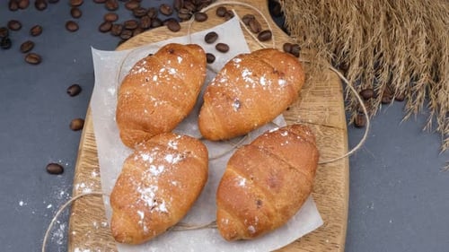 Fresh Croissants with Coffee on Wooden Board