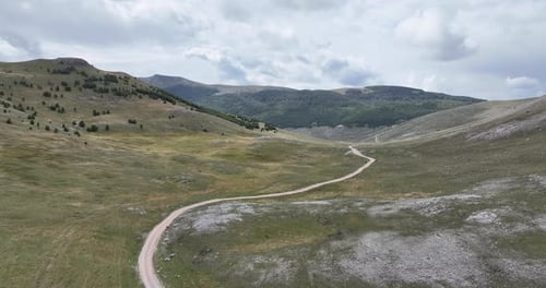 Empty Asphalt Road on the Plateau Between Green Fields Aerial View