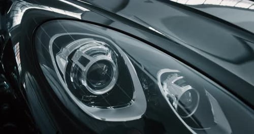 Close up of details of headlights of anonymous prestigious luxury modern car. Shot in 8K. Concept