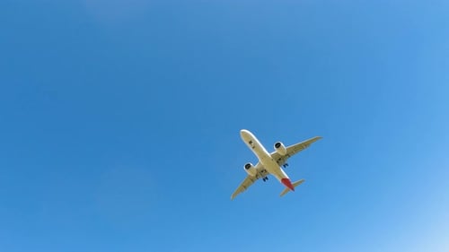 Aircraft landing at airport runway during clear sunny weather